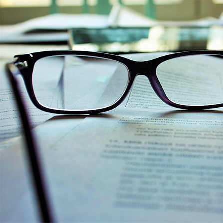 Reading glasses on top of legal documents